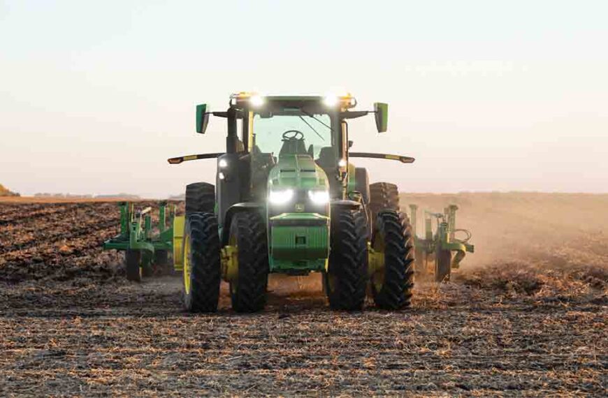 An autonomous tractor ploughs a field.