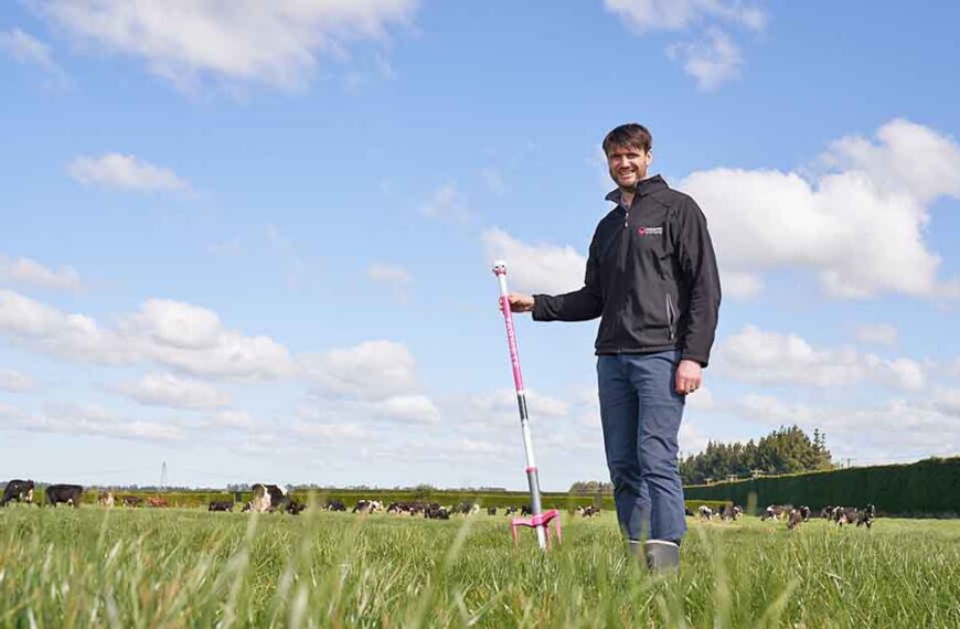 Richard Barton holds a farmote paster mapping tool in a field.